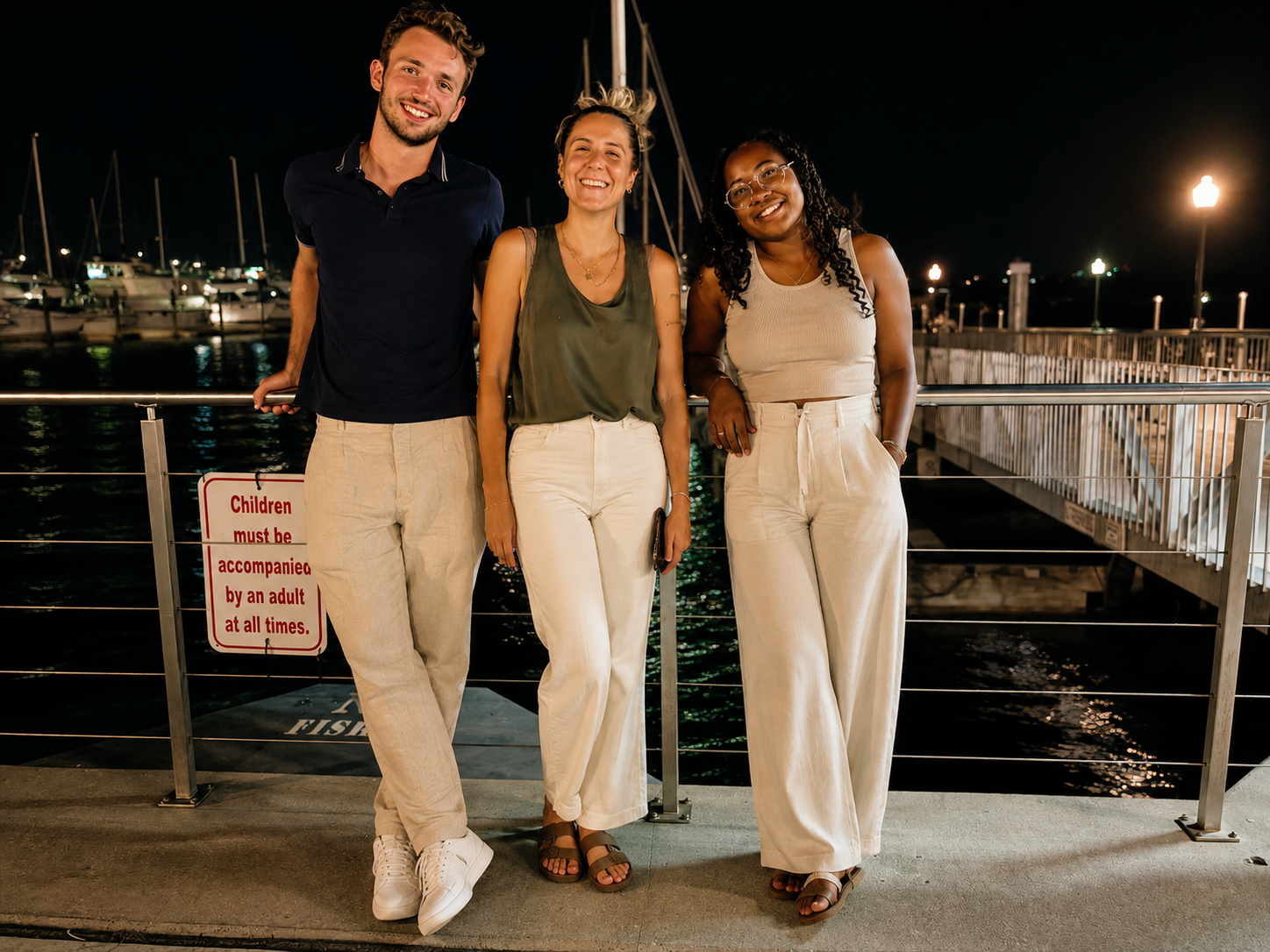 Three Eleva Group team members together at the Miami marina in the evening